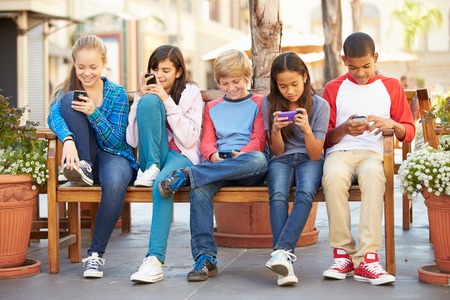 Group Of Kids Using Cell Phones